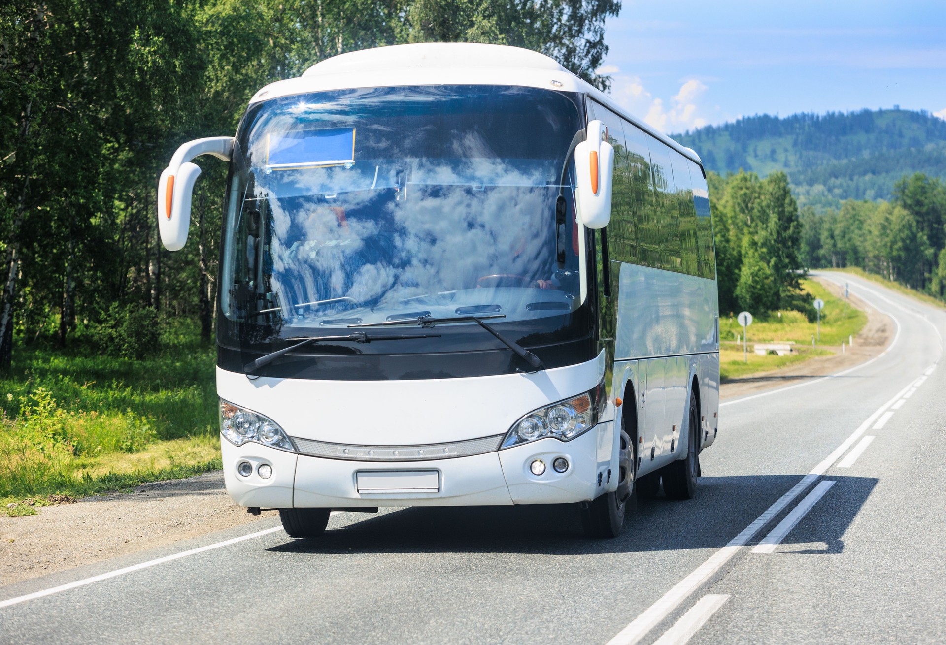 tourist bus moves along a country road